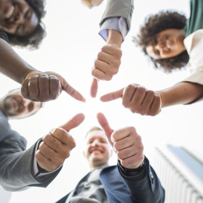 Business people giving a thumbs up
